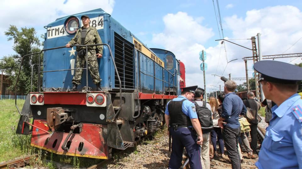 A Ukrainian policeman watches as a train carrying the remains of the victims of Malaysia Airlines MH17 downed over rebel-held territory in eastern Ukraine arrives in the city of Kharkiv in eastern Ukraine . Photograph: Gleb Garanich/Reuters
