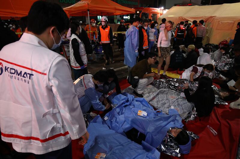 Emergency services treat injured people at the scene of the incident. Photograph: Chung Sung-Jun/Getty Images