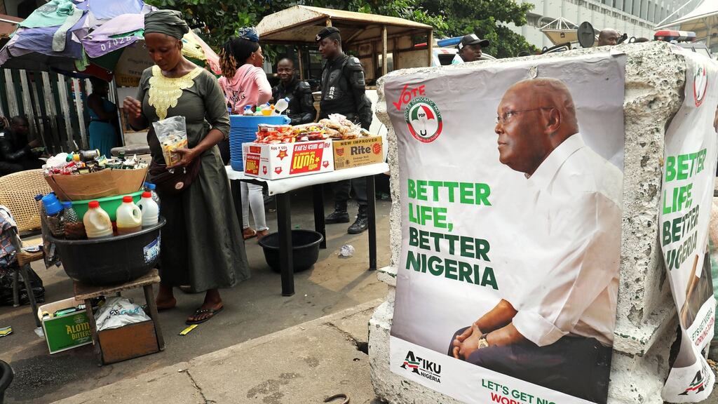 A street vendor is pictured next to a campaign poster of Atiku Abubakar, leader of the People’s Democratic Party (PDP) in Lagos, February 12t. Photograph: Reuters/Luc Gnago