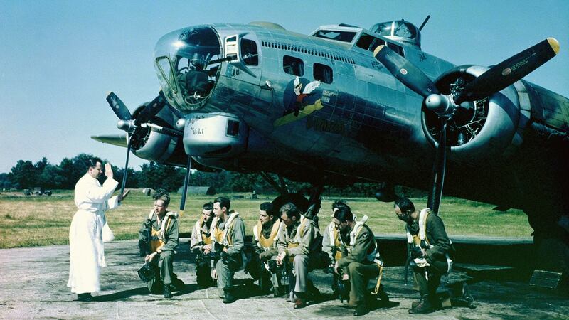 A priest leading the prayers of a B-17 Flying Fortress bomber crew at an airfield in southern England, 1944. Photograph: Galerie Bilderwelt/Getty Images