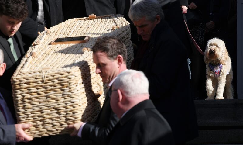 Former RTE journalist Charlie Bird's dog Tiger follows his coffin as it's brought from the Mansion House in Dublin after his memorial service
Photograph: Laura Hutton