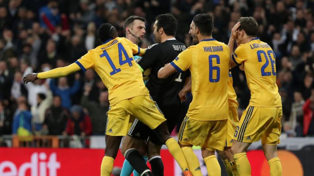 Juventus goalkeeper Gianluigi Buffon confronts referee Michael Oliver before being sent off during the dramatic quarter final against Real Madrid at the Bernabeu. Photograph: Susana Vera/Inpho