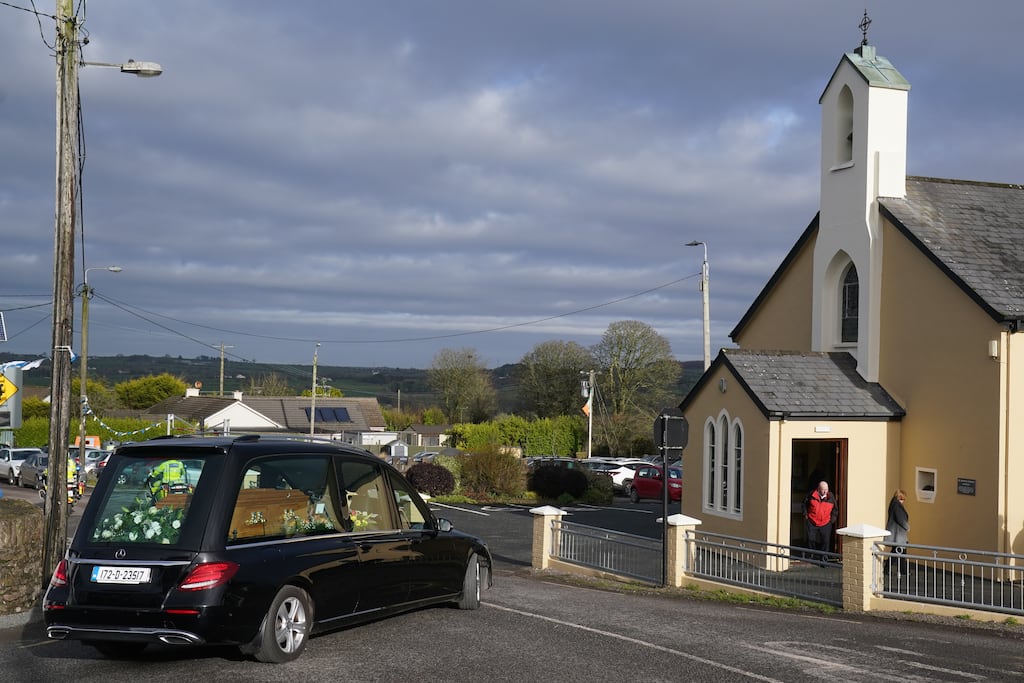 The hearse carrying the coffin of Matthew Healy arrives at St Mary's Church in Berrings, Co Cork, on Thursday. Photograph: Brian Lawless/PA