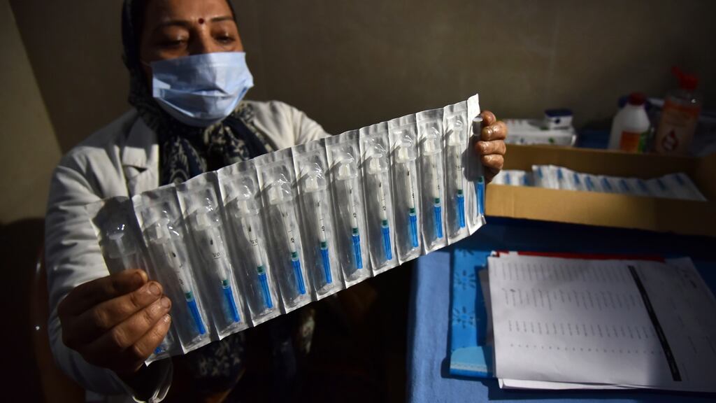 A health worker holds mock Covid-19 vaccine syringes during a dry run of vaccination at a government hospital in Jammu, India, on Saturday. Photograph: Jaipal Singh/EPA