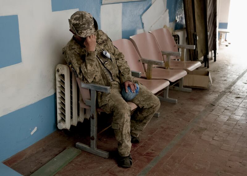 A Ukrainian soldier waiting to be transferred to a hospital at a stabilisation point in the Zaporizhzhia region of Ukraine. Photograph: Emile Ducke/The New York Times