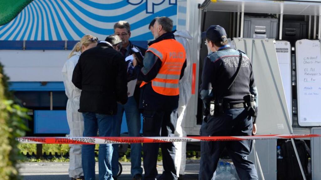 Policemen and forensic experts at the scene where three bodies were discovered  in Wilderswil, Switzerland today. Photograph: EPA