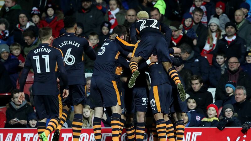 Newcastle United’s Daryl Murphy is mobbed by team-mates after scoring his side’s second goal in their Championship win over Brentford. Photo: Simon Cooper/PA