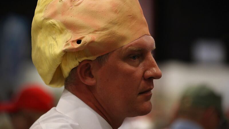 Derek Olsen wears a mask of Republican presidential candidate Donald Trump during his campaign rally in West Palm Beach, Florida. Photograph: Joe Raedle/Getty Images