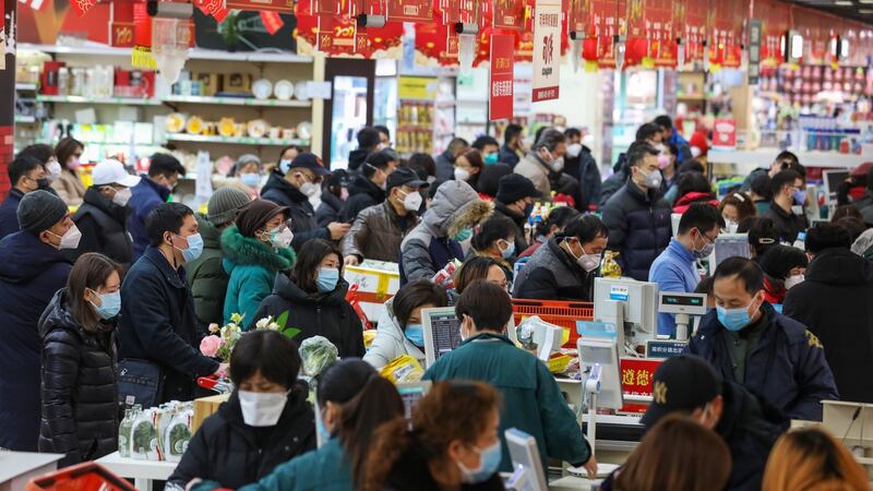 Shoppers wearing masks wait to check out of a supermarket in Wuhan in central China’s Hubei province on Saturday, January 25th, 2020. The city, struck by the coronavirus outbreak, will ban private traffic in the downtown area starting from Sunday, prompting citizens to go on a shopping spree for necessities. Photograph: Yuan Zheng/EPA