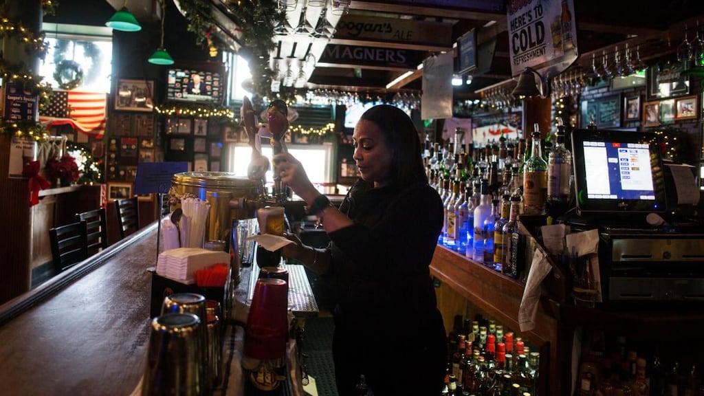 Bartender Belgica Borges pours a beer at Coogan’s. Photograph: Victor J Blue/New York Times