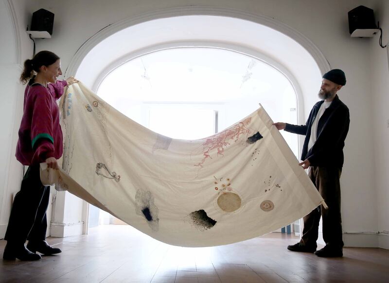 Artists Paula McCloskey and Sam Vardy pictured installing a textile piece from their work ‘The 9 Freedoms for the Air’. Photograph: Mark Stedman