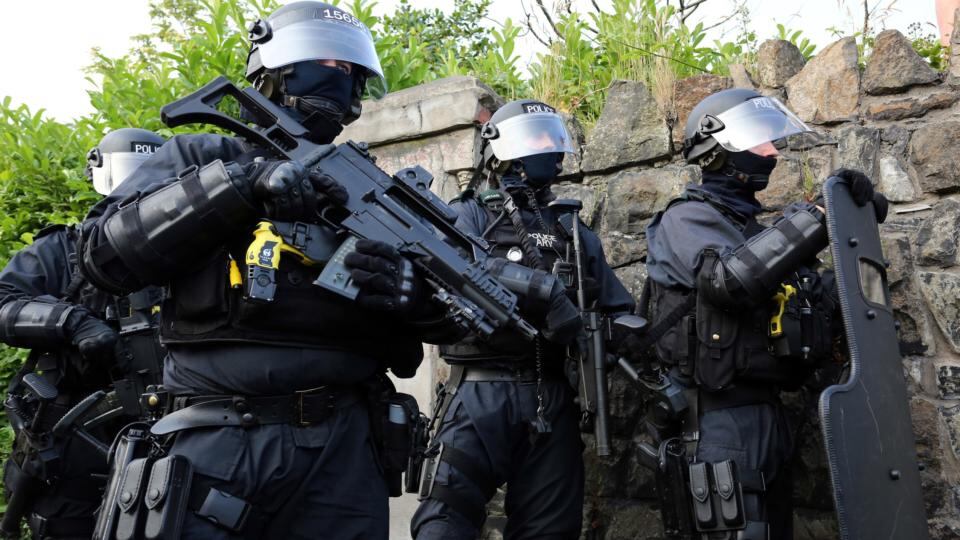 Armed police officers appear after an Orange July 12th parade was stopped from passing a Nationalist area in north Belfast. Photograph: Paul Faith/PA Wire