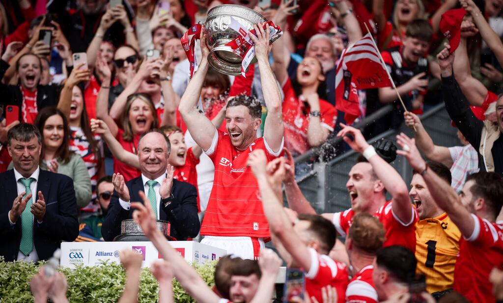 Louth captain Sam Mulroy raises the Delaney Cup after his county's Leinster final win over Meath. Photograph: Tom Maher/Inpho