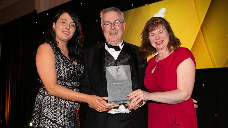 Prof. Louis Brennan, Trinity Business School presents the Best Language School award to Sinéad Morrissey and Micheline Bradley, Cork English College