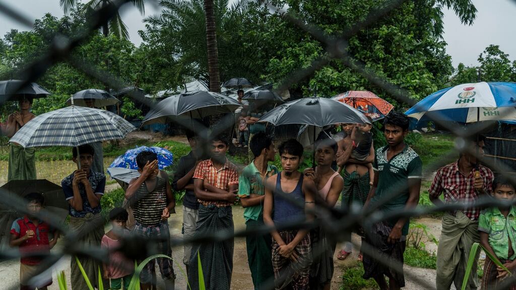 Rohingya Muslims behind barbed wire in the Taung Pyo border area where they are stranded between Myanmar and Bangladesh. Photograph: Adam Dean/The New York Times