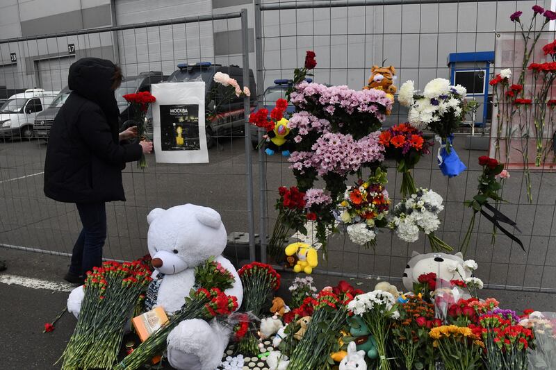 A woman lays flowers at a makeshift memorial in front of the Crocus City Hall, a day after a gun attack in Krasnogorsk, outside Moscow, on March 23th, 2024. Photograph: Getty