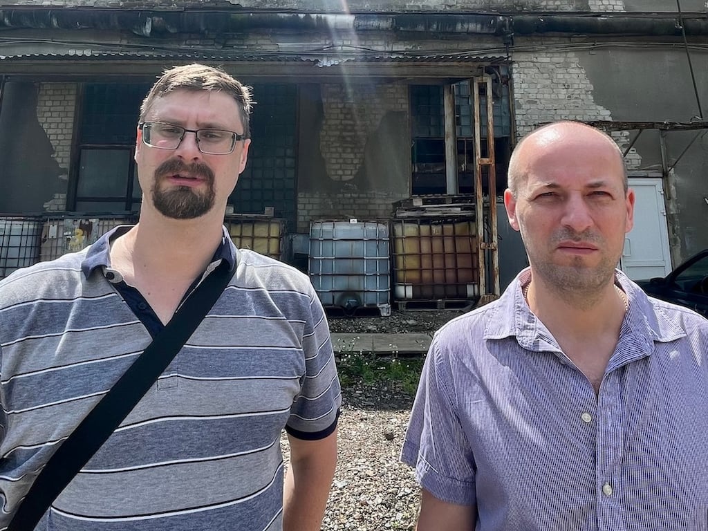 Oleksandr Sorokin (left), deputy director of science at the Institute for Scintillation Materials in Kharkiv and chief engineer Serhiy Kovalchuk, outside one of the institute's damaged buildings. Photograph: Daniel McLaughlin