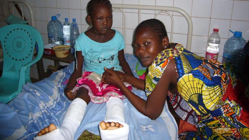 Gracia Dongo (7) and her mother Sidonie. Both of Gracia’s feet were shattered by bullets as her father drove her to school. Photograph: Lara Marlowe