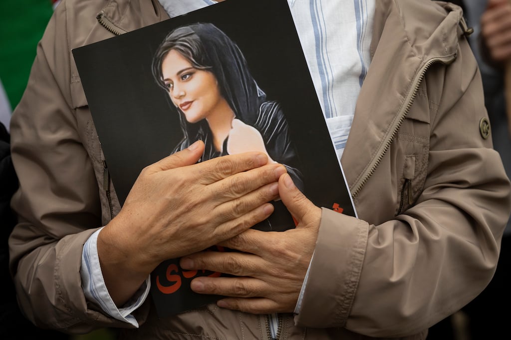 A portrait of Mahsa Amini is held during a rally calling for regime change in Iran in Washington in 2022. Photograph: Cliff Owen/AP