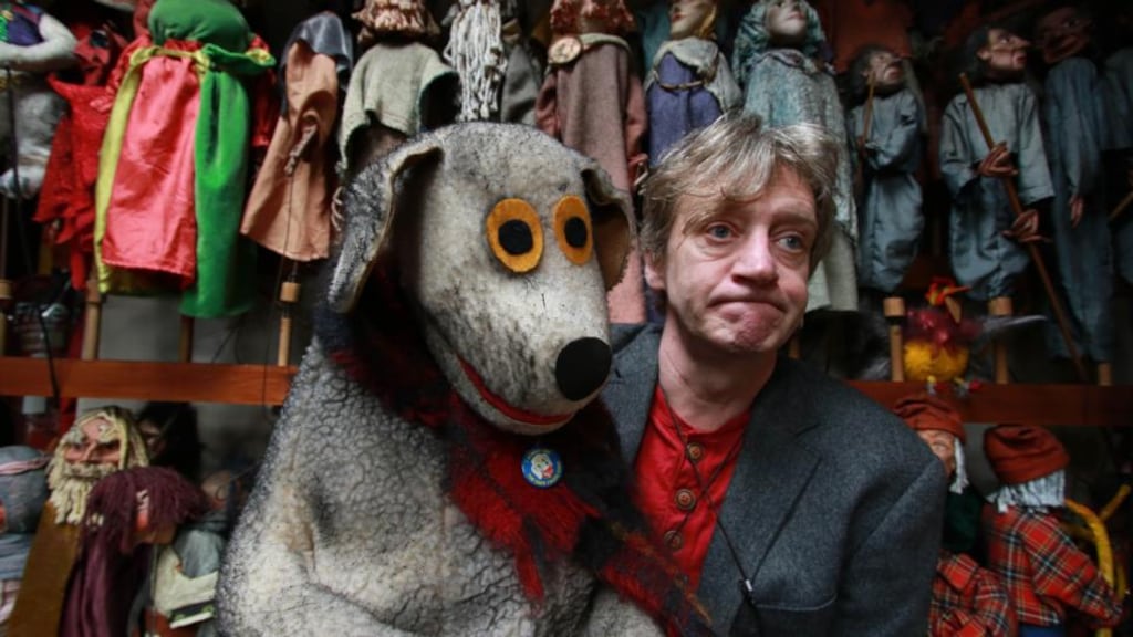 Liam Lambert in a fire-damaged part of the Lambert Puppet Theatre, with Judge. Photograph: Nick Bradshaw/The Irish Times