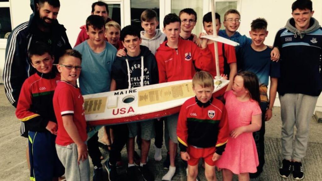 Students of Teach Ailín Coláiste Árainn Mhóir on Donegal’s Arranmore island, with The Red Storm, the model boat launched almost six months ago off the coast of New Hampshire in the US, and found by the students close to their college. Photograph: Noel Gaughran