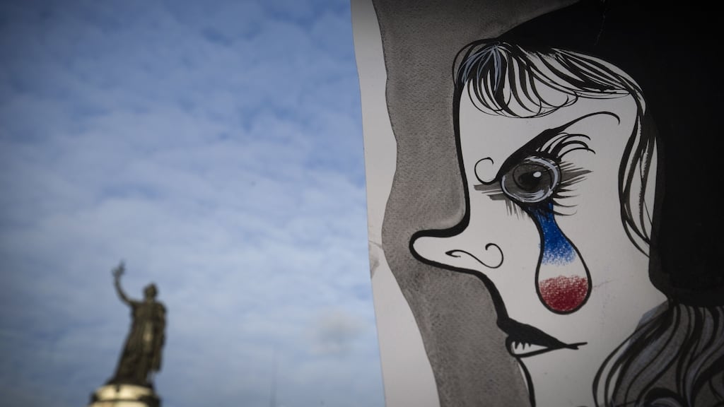 A painting by Liox in front of the Republic statue in Paris: France has reimposed border controls. Photograph: Joel Saget/AFP/Getty Images