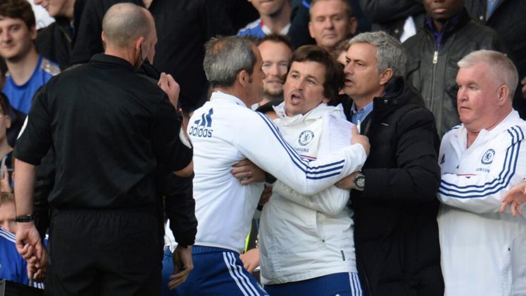 Chelsea manager Jose Mourinho helps hold back assistant coach Rui Faria (centre) after he was sent off by referee Mike Dean during their Premier League match against Sunderland at Stamford Bridge. Photograph: Philip Brown/Reuters