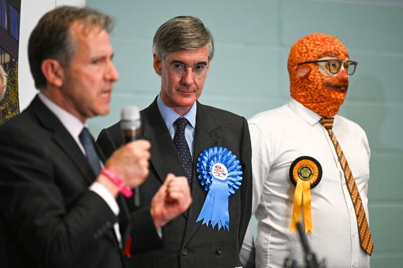 Conservative candidate Jacob Rees-Mogg stands next to Barmy Brunch from The Official Monster Raving Loony Party as Labour candidate Dan Norris speaks during the declaration for the North East Somerset constituency. Photograph: Finnbarr Webster/Getty Images