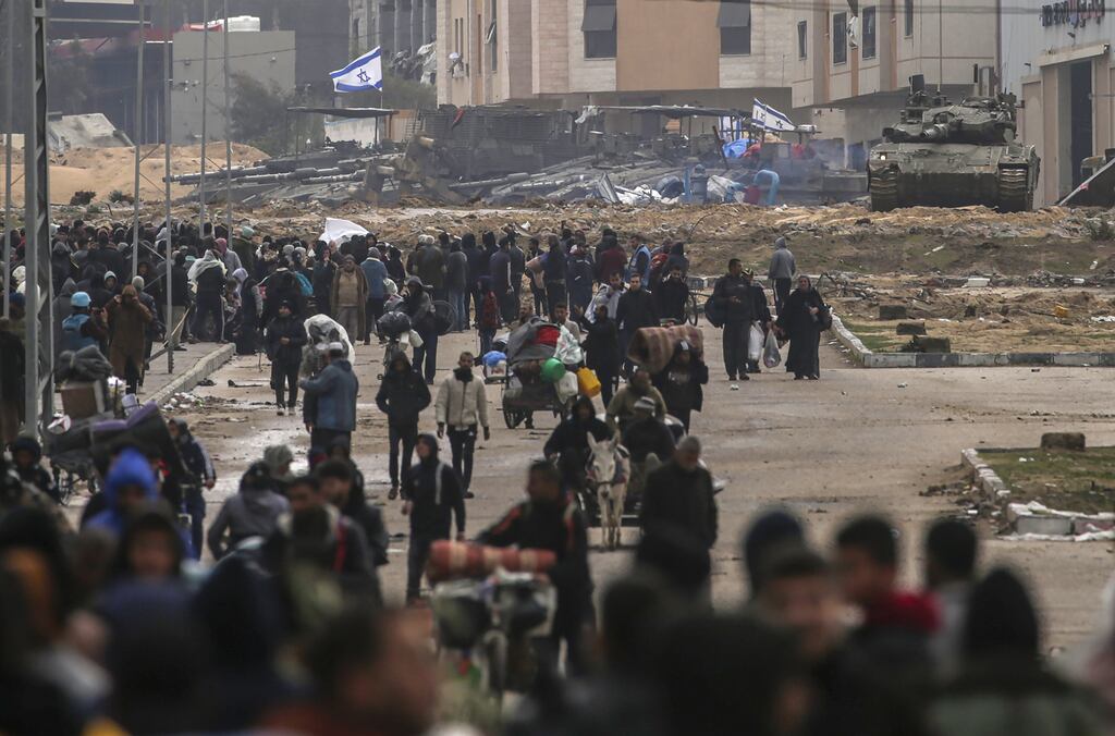 Internally displaced Palestinians move past Israeli tanks after the Israeli army told residents of Khan Yunis camp to leave their homes and head towards Rafah camps near the Egyptian border on Saturday. Photograph: Mohammed Saber/EPA