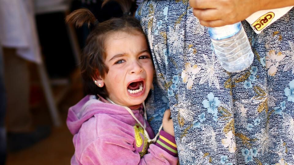 A Syrian refugee girl cries while clutching to her mother as they arrive at the Syrian-Turkish border near Sanliurfa, today. In the recent days Turkey has seen the ‘biggest influx’ of Syrian refugees since the start of the war three years ago, a spokeswoman for the UN agency for refugees (UNHCR) said. The Turkish government figure includes about 140,000 people who fled Kurdish villages in northern Syria to escape an ongoing  attacks by the Islamic State militant group. Photograph: EPA