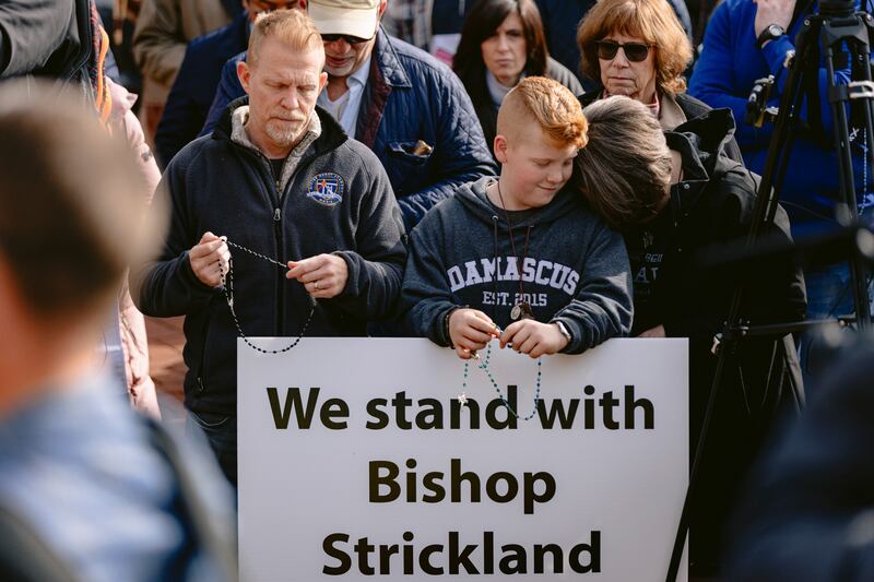 Tim, Luke and Tina McMorland listen to Bishop Joseph Strickland during a rally to support him outside the US Conference of Catholic Bishops in Baltimore in November 2023. Photograph: Wesley Lapointe/New York Times