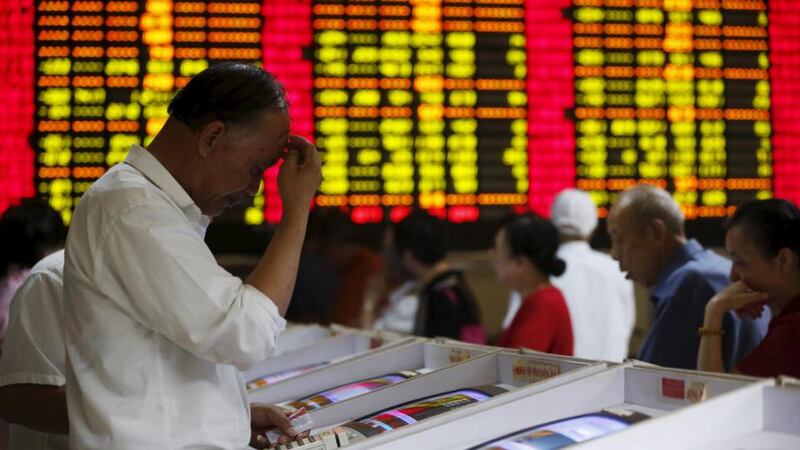 Investors look at computer screens showing stock information at a brokerage house in Shanghai recently. Photograph: REUTERS/Aly Song