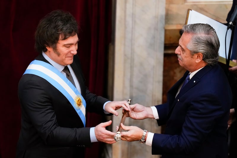 Javier Milei receives the presidential cane from outgoing President Alberto Fernandez in Buenos Aires. Photograph: Natacha Pisarenko/AP