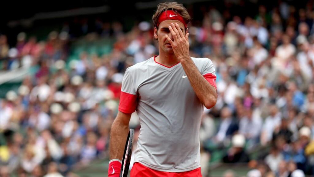 Roger Federer reacts during his men’s singles match against Ernests Gulbis of Latvia on day eight of the French Open at Roland Garros. Photograph: Matthew Stockman/Getty Images