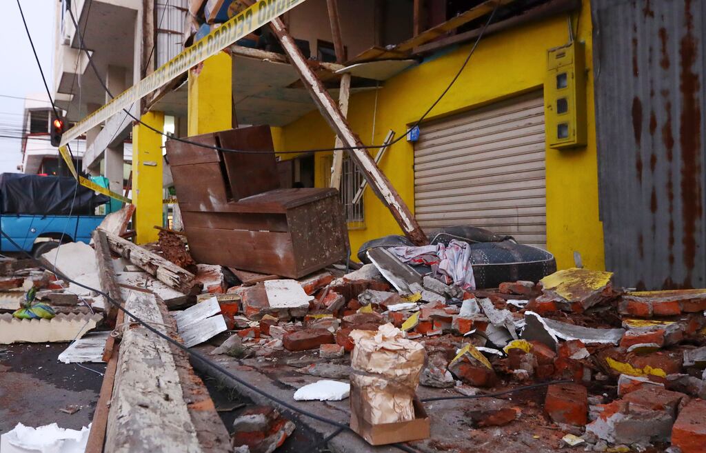 Debris from collapsed homes are scattered on a street after an earthquake shook Machala, Ecuador. Photograph: Cesar Munoz/AP