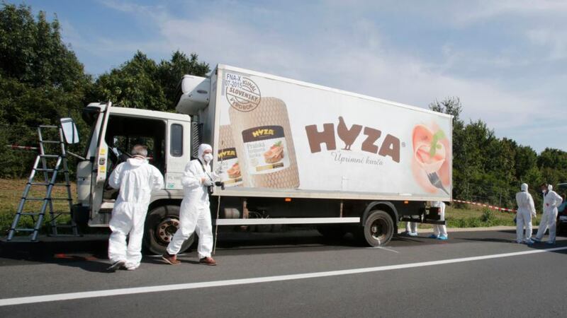 Forensic police officers inspect a parked truck in which up to 50 migrants have been found dead on a motorway near Parndorf, Austria, August 27th, 2015. Photograph: Heinz-Peter Bader/Reuters