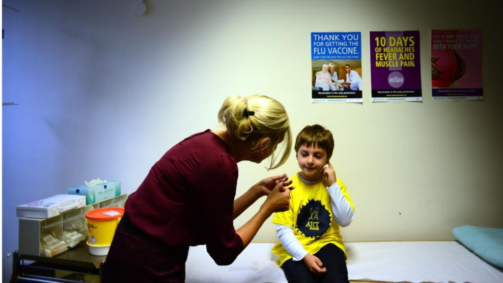 Seven-year-old Oisín Blaney Shorte, from Terenure, Dublin, who has asthma, with clinical nurse manager Bríd Ryan O’Malley at Dr Steeven’s Hospital, where the HSE simulated giving a vaccination jab. Photograph: bryan O’Brien