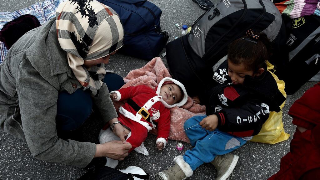 Refugees and migrants after disembarking a ferry at the port of Piraeus, in Greece, following their arrival from the northeastern  island of Lesbos, on Tuesday. Two ferries with more than 520 refugees and migrants docked at the port during the day. Photograph: Simela Pantzartzi/EPA