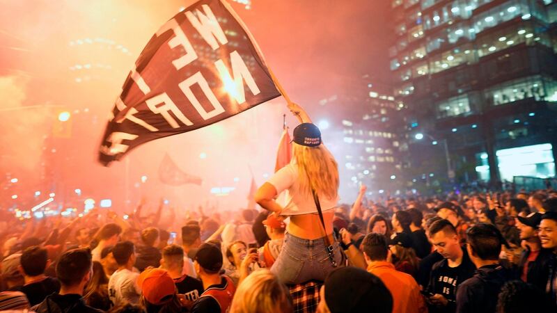 Mass celebrations broke out in downtown Toronto. Photo: Geoff Robins/Getty Images