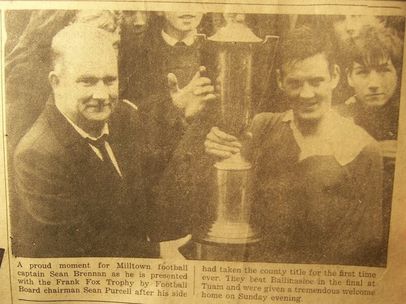 Seán Brennan being presented with the Frank Fox Cup by then-Galway football board chairman Seán Purcell