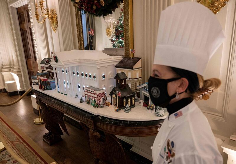White House Christmas: pastry chef Susan Morrison with a ginger-bread White House in the State Dining Room. Photograph: Andrew Caballero-Reynolds/AFP via Getty