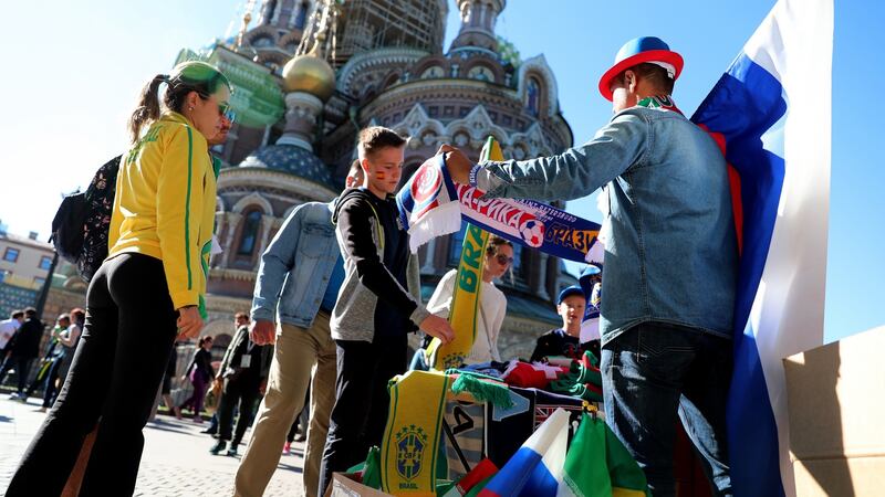 A street vendor sells flags and scarfs in front of St Isaac’s Cathedral near the Fan Fest area in St Petersburg. Photograph: EPA