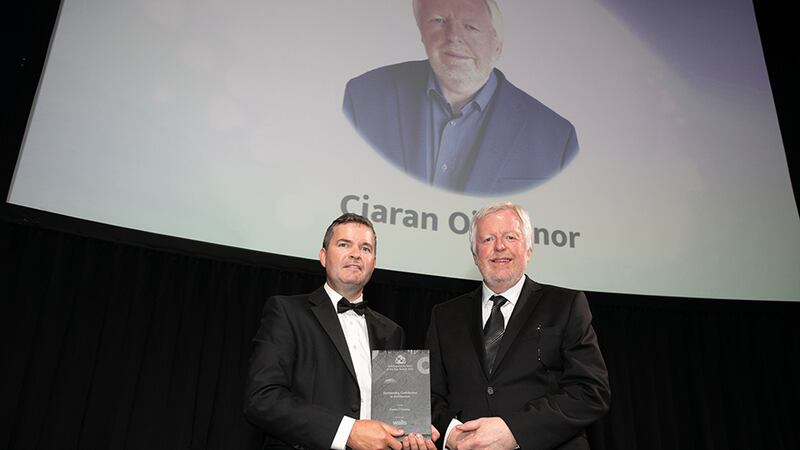 James O'Toole, Construction Director, Walls Construction, presents the Outstanding Contribution to Architecture award to Ciaran O’Connor.