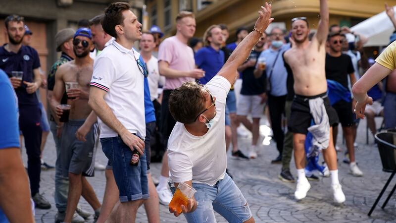 A fan gets ready to throw his pint into the air. Photo: Adam Davy/PA Wire