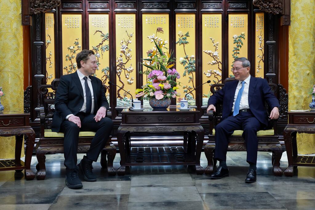 Tesla founder Elon Musk, left, meets with Chinese Premier Li Qiang in Beijing. Photograph: Wang Ye/Xinhua via AP
