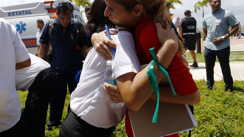 A group of people are evacuated with hundreds of other passengers on the cruise ship ’Caribbean Fantasy’ after a fire started off the coast of San Juan, Puerto Rico. Photograph:Thais Llorca/EPA