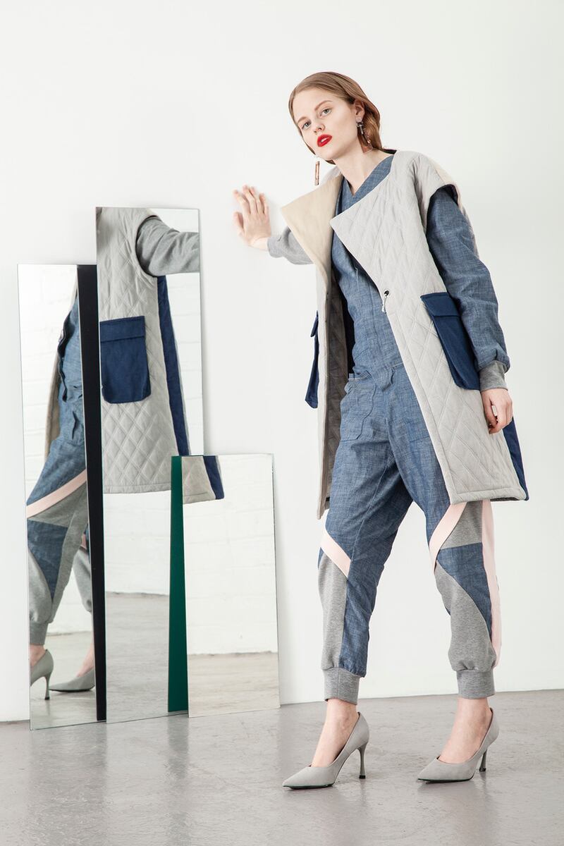 Ice blue organic quilted denim gilet with utility pockets €275, jumpsuit with dolman puffed sleeve in denim with jersey panels €225, grey suede stilettos Zara €25.95, brown Perspex earring Om Diva €28