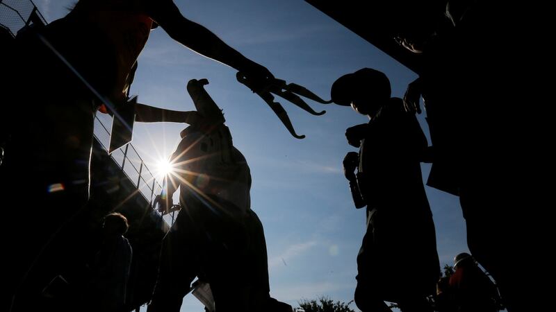 Eclipse glasses are passed around at a football stadium at Southern Illinois University in Carbondale, Illinois, US. Photograph: Brian Snyder/Reuters