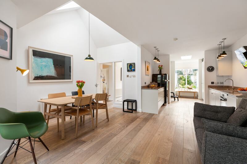 The kitchen/living/dining room looking from the back to the front of the house.