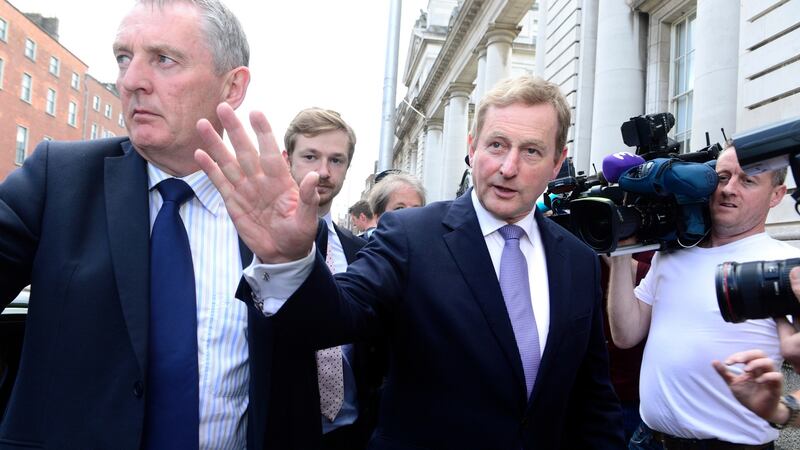 Taoiseach Enda Kenny waves to wellwishers as he leaves Government Buildings to go to Áras an Uachtaráin to resign on Tuesday. Photograph: Cyril Byrne